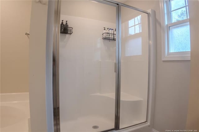 bathroom with a shower with door