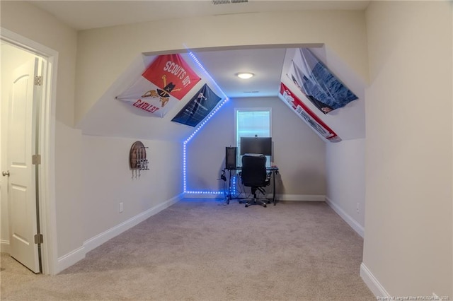 carpeted office featuring vaulted ceiling