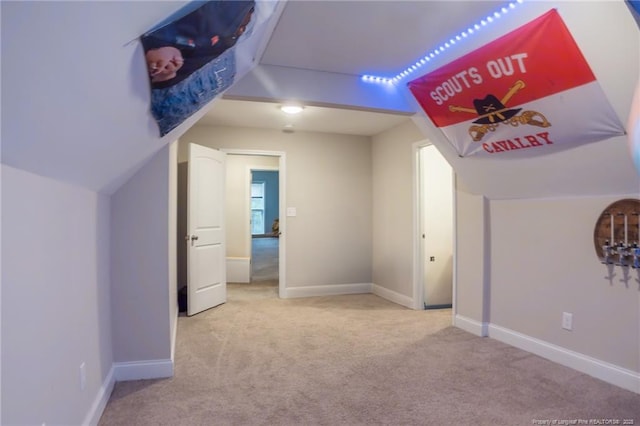 bonus room with lofted ceiling and carpet floors