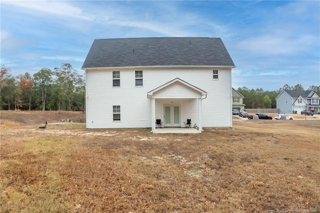 view of front of home featuring a front lawn and a patio