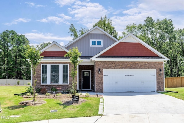 craftsman house with a garage and a front lawn