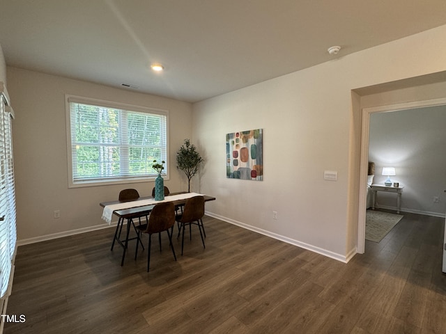 dining space with dark wood-type flooring