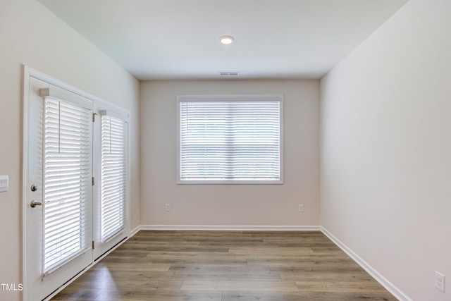 empty room with hardwood / wood-style flooring