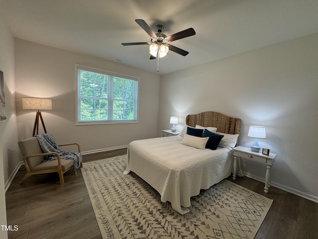 bedroom with ceiling fan and dark hardwood / wood-style flooring