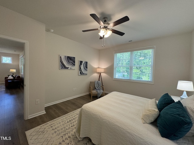 bedroom with ceiling fan and dark hardwood / wood-style floors