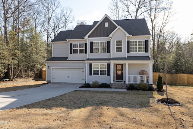 front of property featuring a garage, a front yard, and covered porch