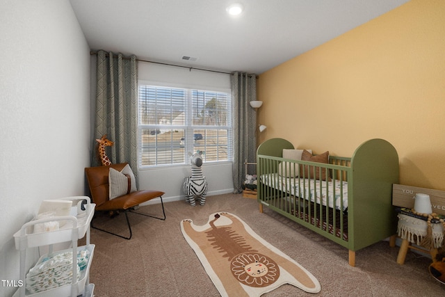 carpeted bedroom featuring a crib