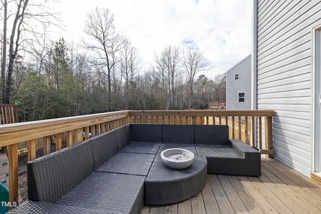 wooden terrace with an outdoor living space