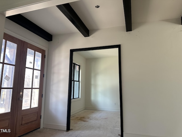 entryway with beamed ceiling, plenty of natural light, and french doors