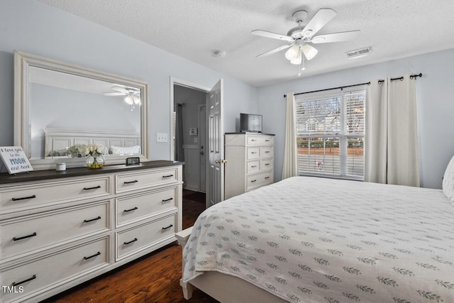 bedroom with dark hardwood / wood-style flooring and a textured ceiling