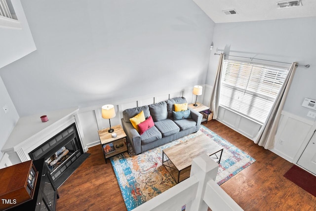 living room with lofted ceiling and dark hardwood / wood-style flooring