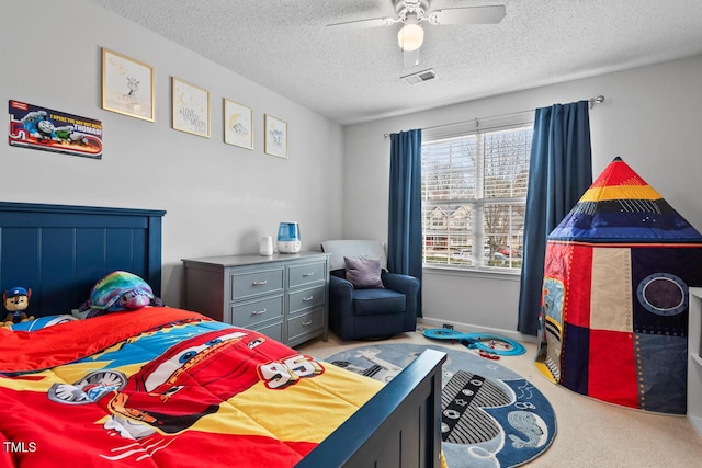 bedroom featuring ceiling fan, light carpet, and a textured ceiling