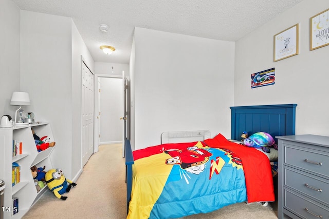 bedroom featuring light colored carpet and a textured ceiling