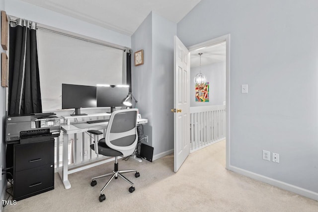 carpeted office featuring a chandelier