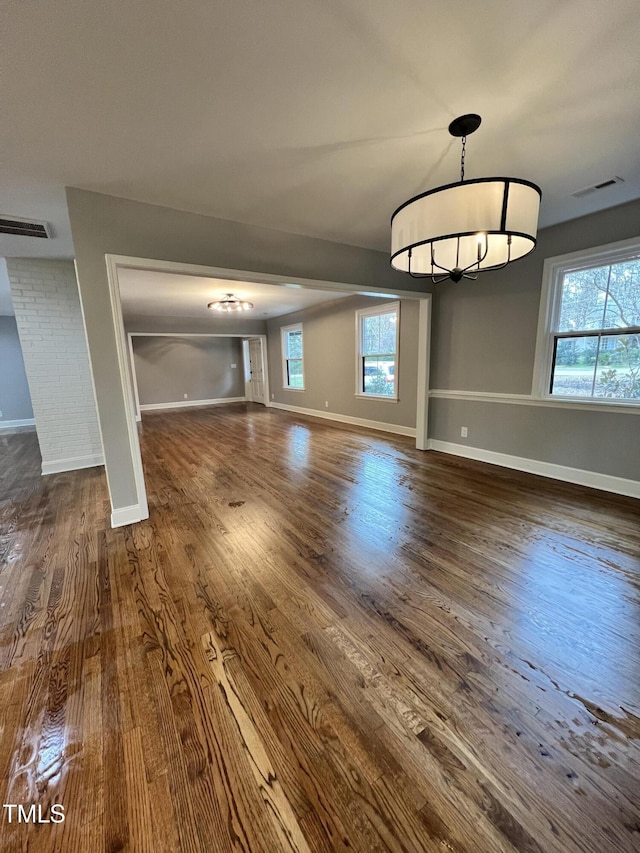 unfurnished living room featuring dark wood-type flooring