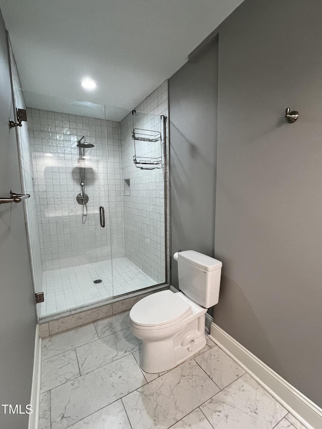 bathroom with a shower with door and toilet