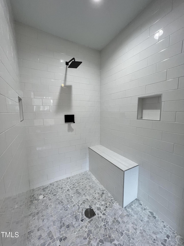 bathroom with tiled shower