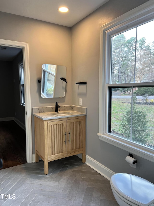 bathroom featuring vanity and toilet