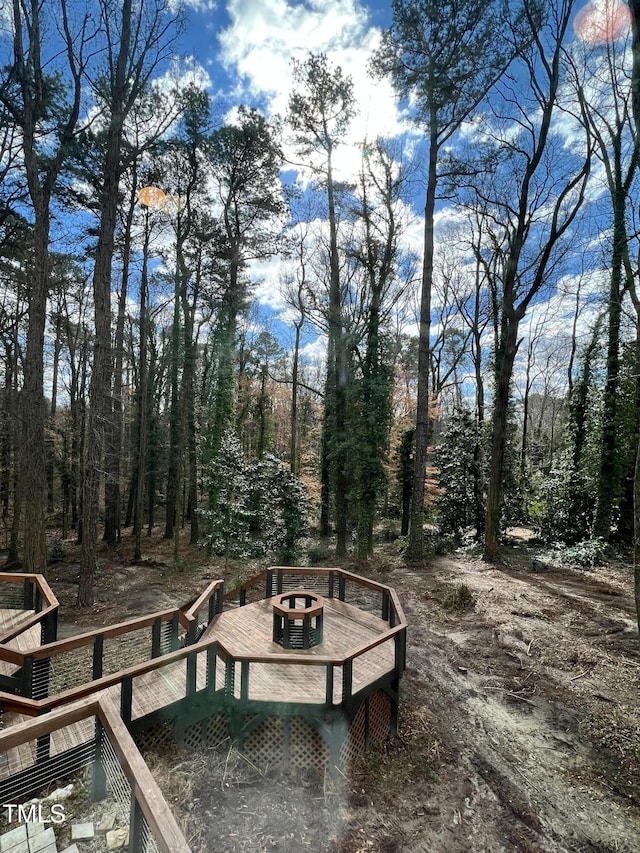 wooden terrace featuring a fire pit