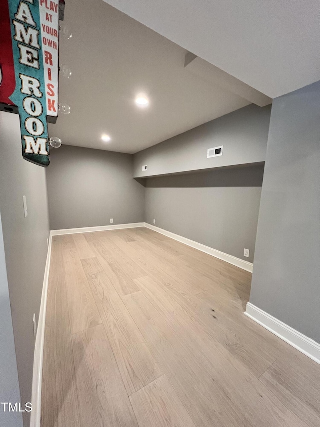 basement with hardwood / wood-style floors