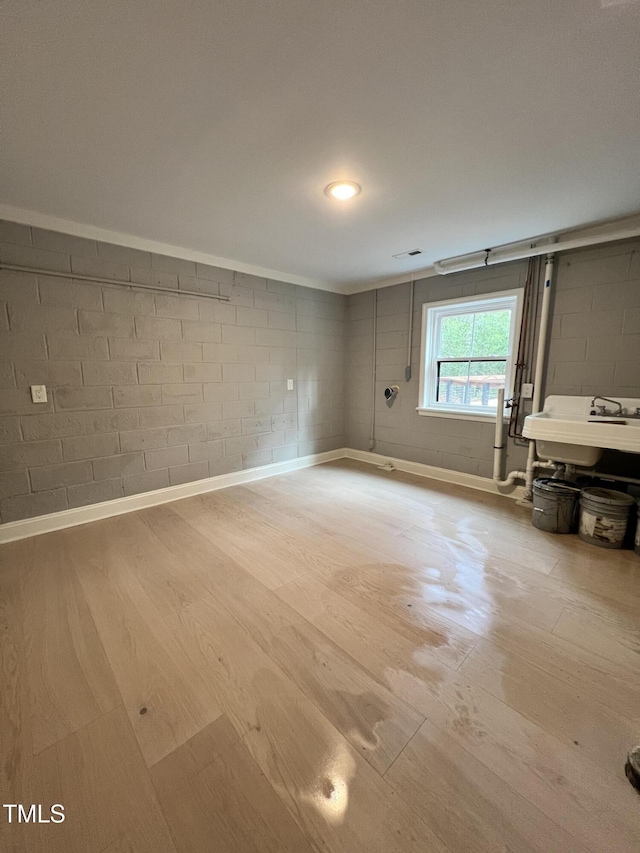 empty room featuring sink and light wood-type flooring