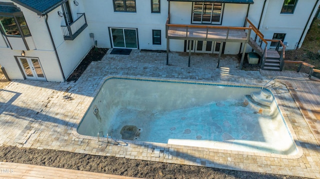 view of pool with french doors and a patio area