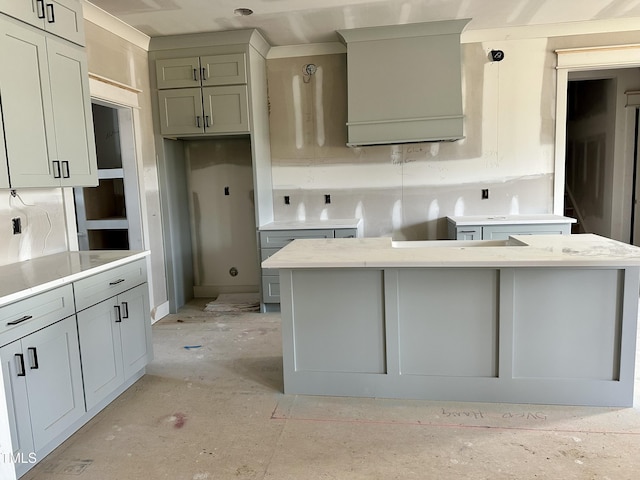 kitchen with gray cabinetry, decorative light fixtures, and a kitchen island