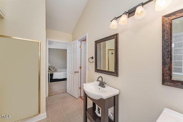 bathroom with lofted ceiling and sink