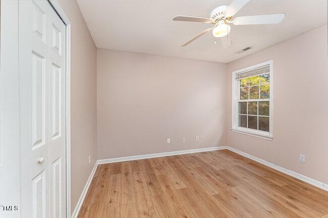 spare room with light hardwood / wood-style flooring and ceiling fan