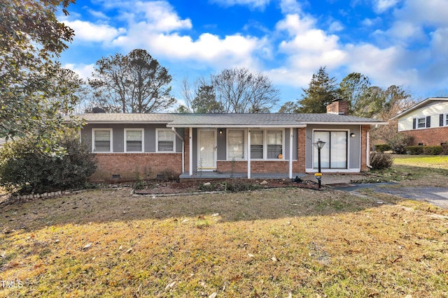 ranch-style house featuring a front yard, crawl space, brick siding, and a chimney