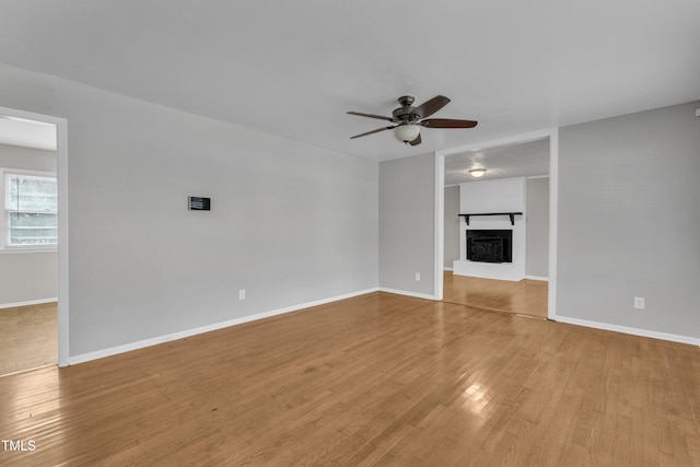 unfurnished living room with light hardwood / wood-style flooring and ceiling fan