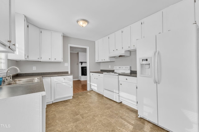 kitchen with sink, white appliances, and white cabinets