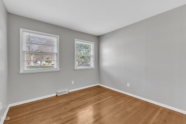 empty room with hardwood / wood-style floors