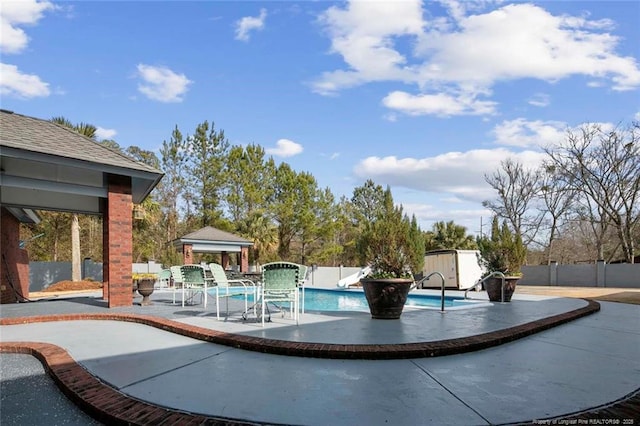 view of swimming pool with a gazebo and a patio