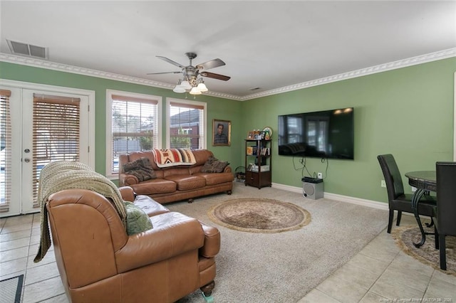 living room with crown molding, ceiling fan, light carpet, and french doors