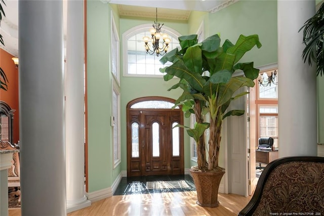 entrance foyer featuring an inviting chandelier, plenty of natural light, and a high ceiling