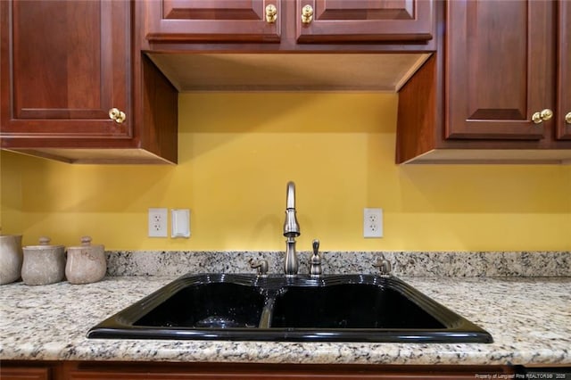 kitchen with light stone counters and sink