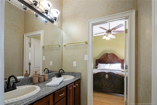 bathroom with hardwood / wood-style flooring, ceiling fan, and vanity