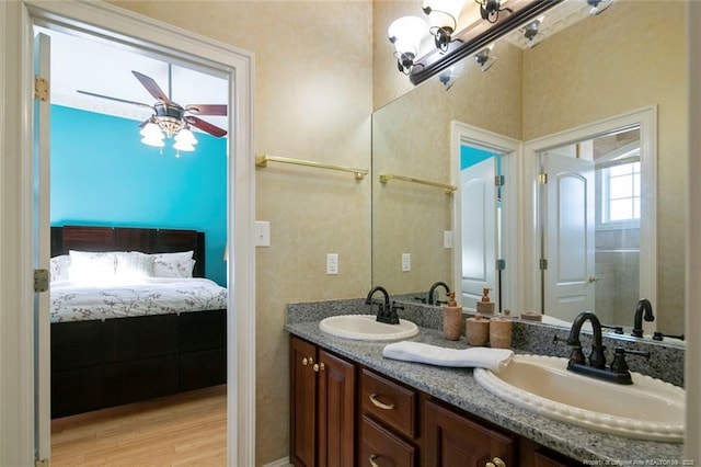 bathroom with ceiling fan, vanity, and wood-type flooring