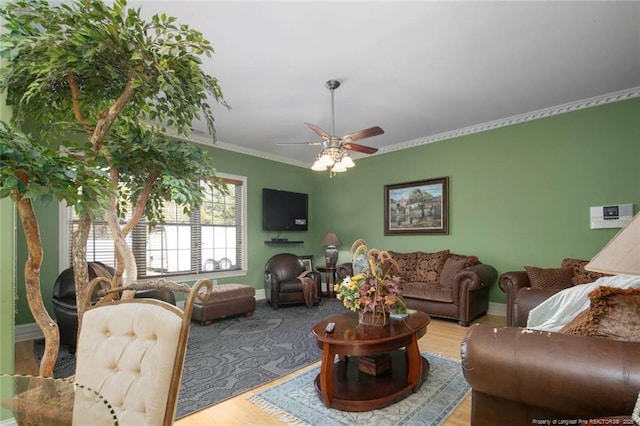 living room with ornamental molding, hardwood / wood-style floors, and ceiling fan