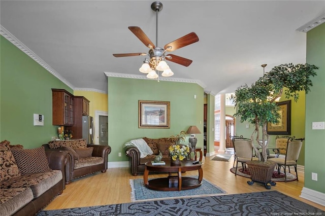 living room featuring crown molding, ceiling fan, and light wood-type flooring