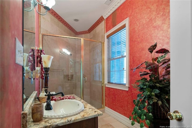 bathroom featuring vanity and a shower with shower door