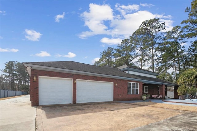 5304 Pineview Rd, Lumberton, NC 28360 - view of front of house featuring a porch, concrete driveway, a garage, and brick siding