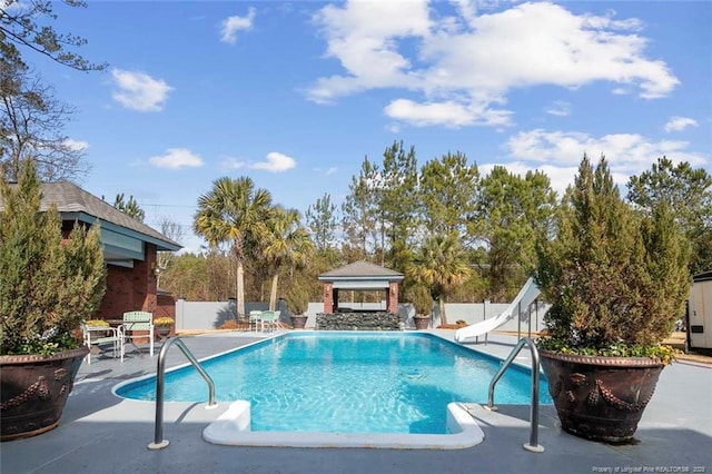5304 Pineview Rd, Lumberton, NC 28360 - view of swimming pool with a gazebo, a water slide, a patio area, and a fenced backyard