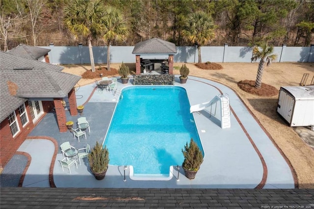 5304 Pineview Rd, Lumberton, NC 28360 - view of swimming pool with a water slide, a fenced backyard, a patio, a gazebo, and an outdoor structure