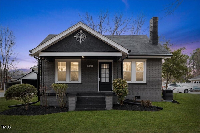 view of front of house with a lawn and a porch