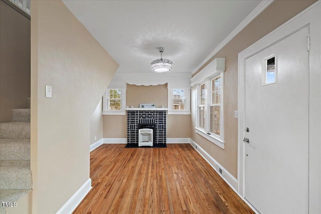 interior space with wood-type flooring and ornamental molding