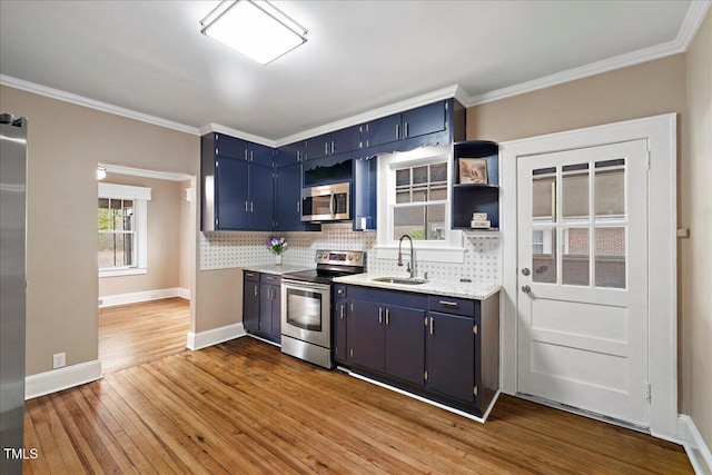 kitchen featuring sink, backsplash, stainless steel appliances, and blue cabinetry