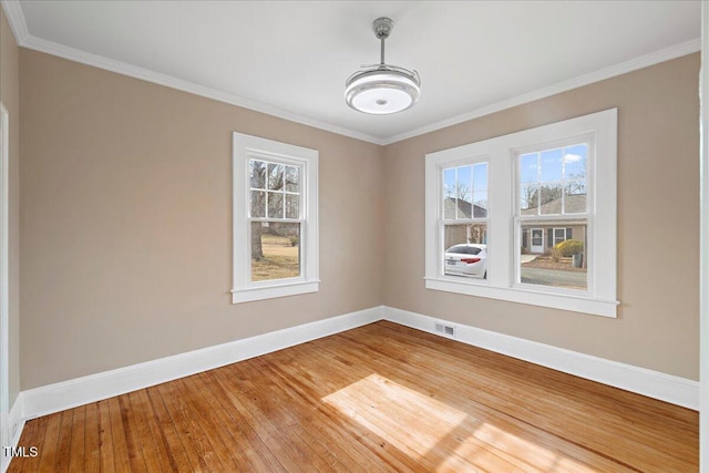 unfurnished dining area featuring ornamental molding and hardwood / wood-style floors