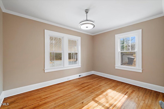 unfurnished room featuring ornamental molding and wood-type flooring